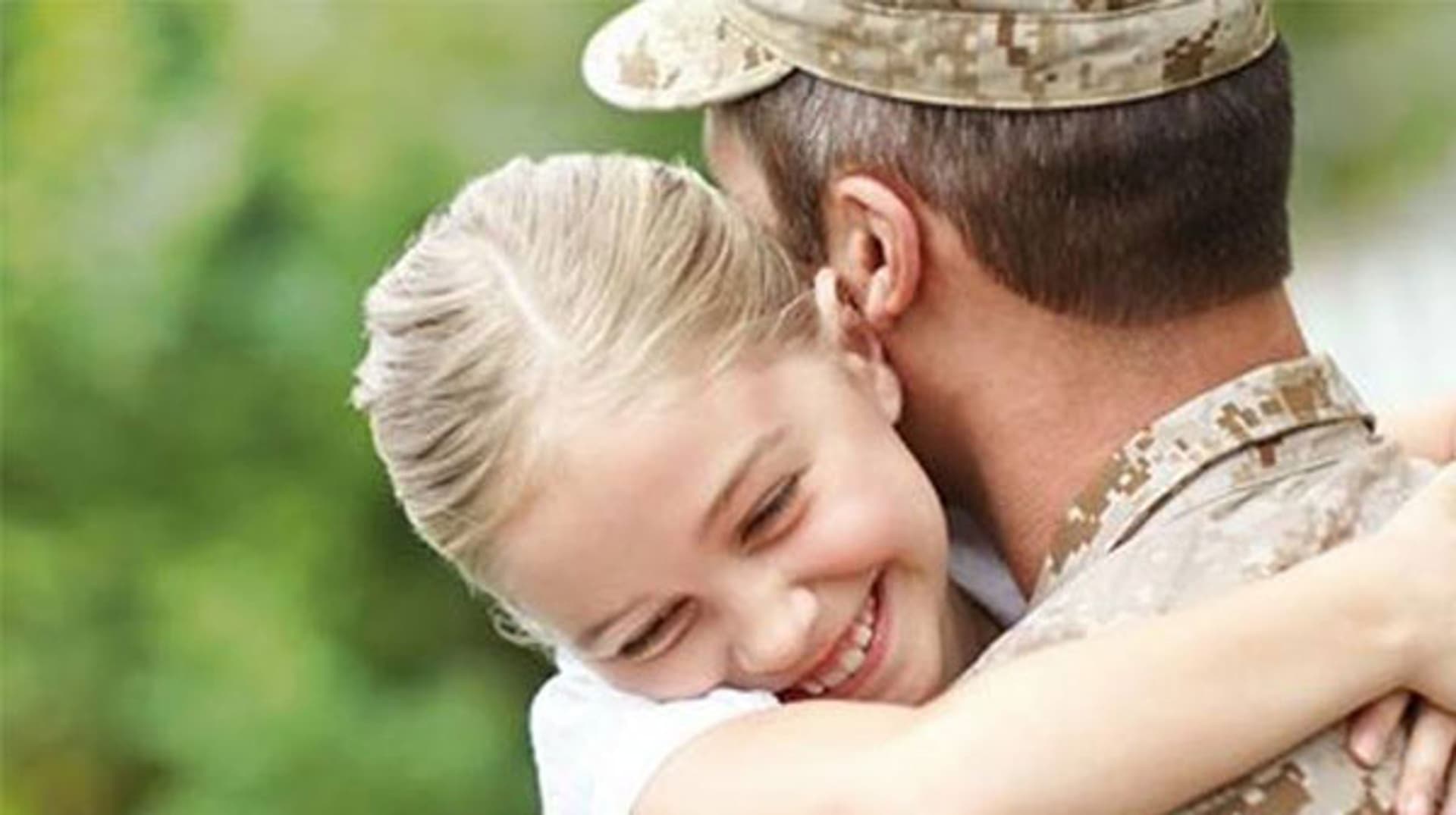 A military member hugging his daughter