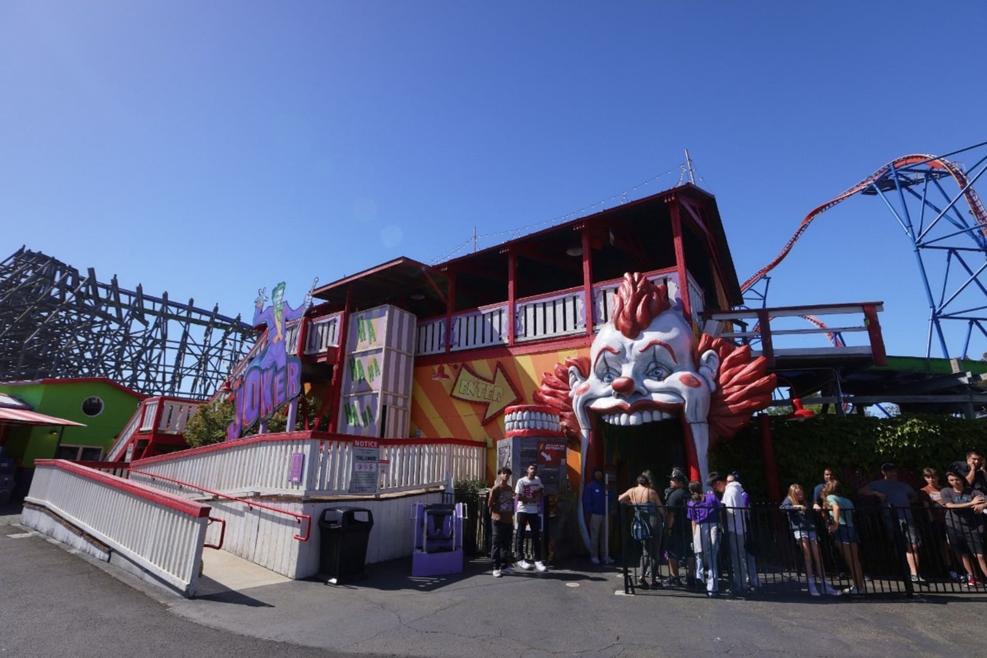 The entrance of THE JOKER roller coaster which features a large clown head with its mouth open for guests to walk into.