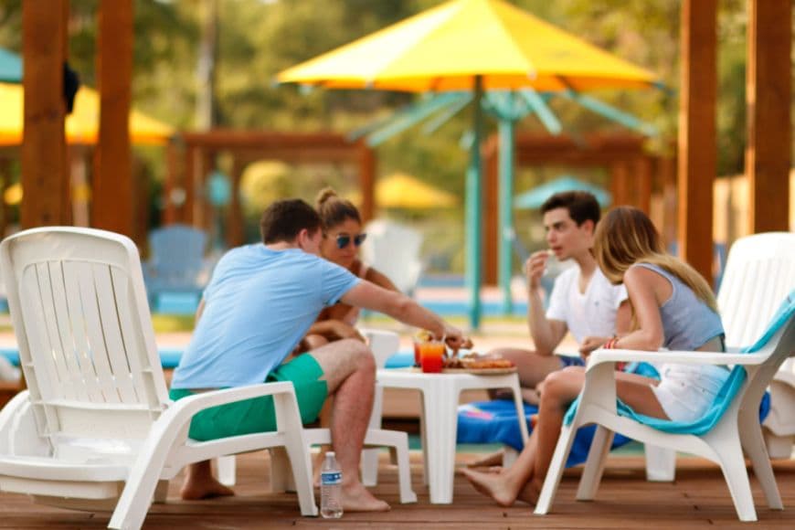 A couple enjoying a meal and loaded nachos at an amusement park.