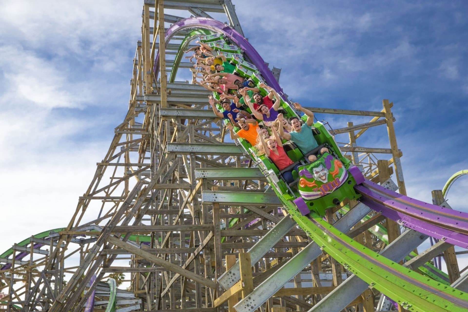 Guests racing through the chaotic twists and turns of THE JOKER roller coaster at Six Flags Discovery Kingdom.