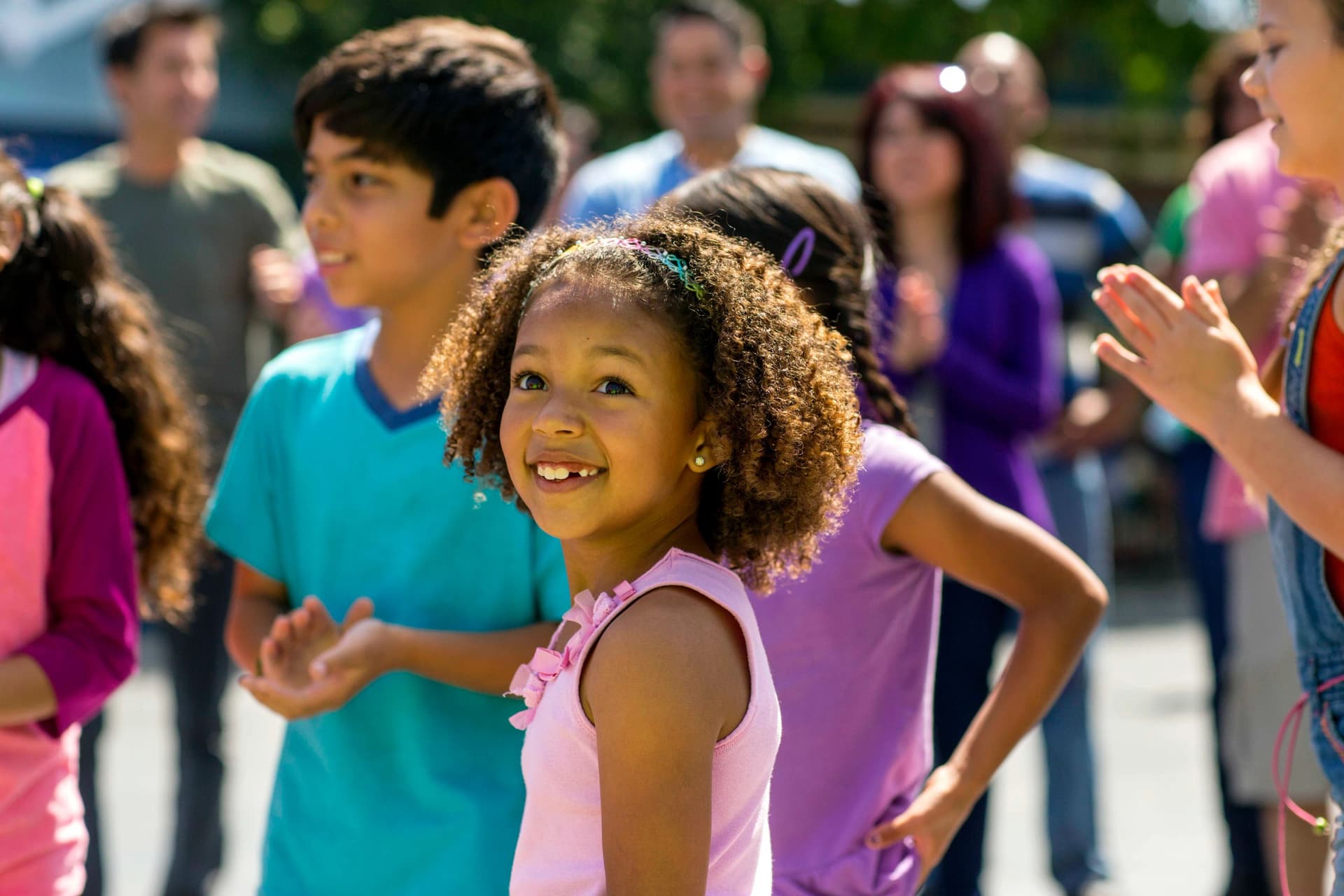 Children smiling while at an amusement park