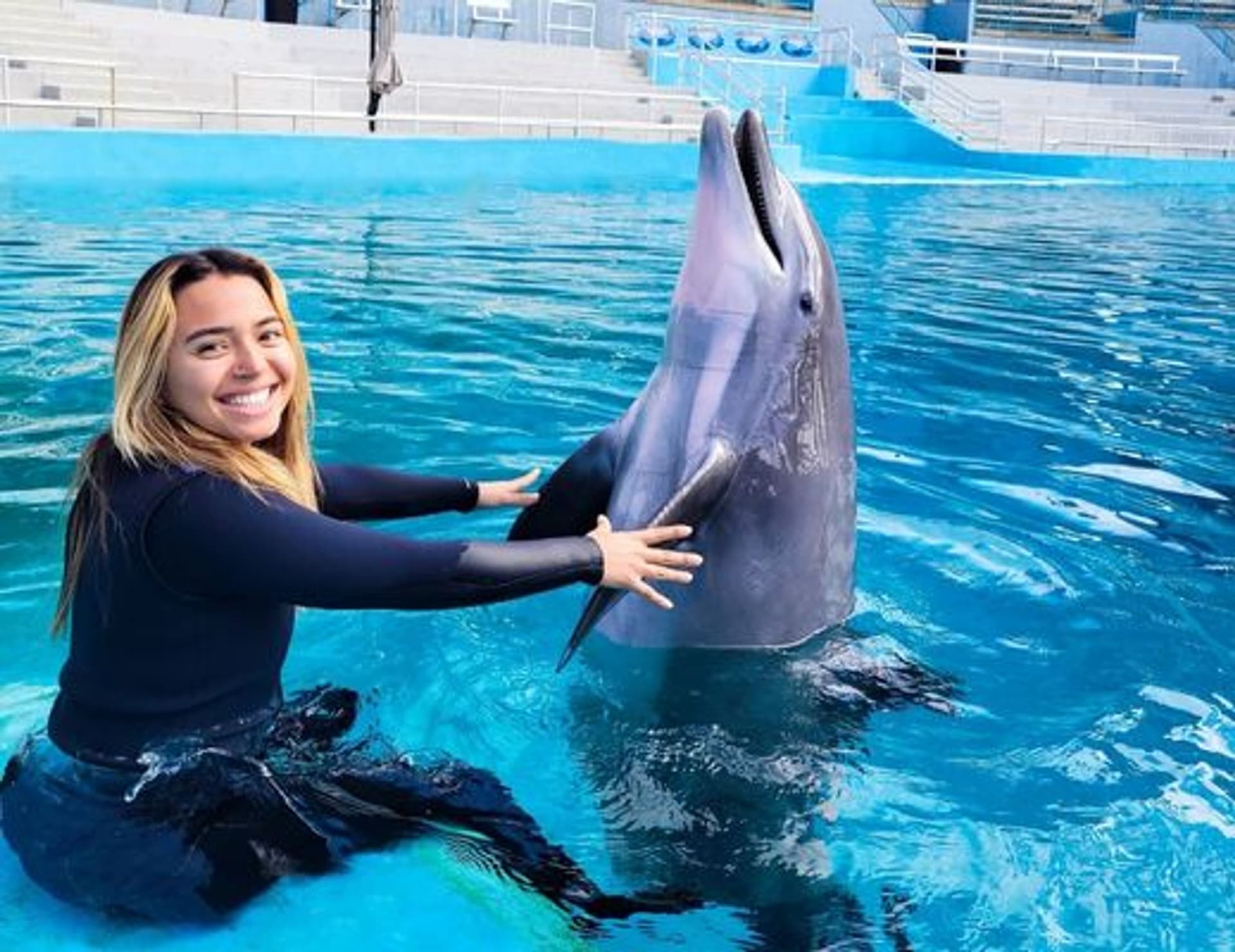 Girl and dolphin in a pool of water