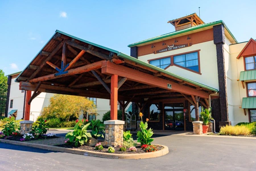 Teenagers running into Lake Erie with Hotel Breakers in the background.