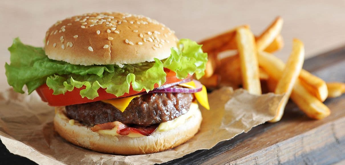 A juicy hamburger and fresh cut fries.