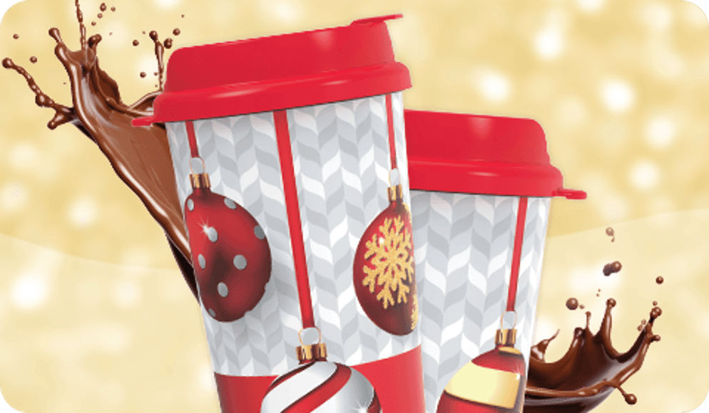 Two hot chocolate mugs with hot chocolate splashing around them